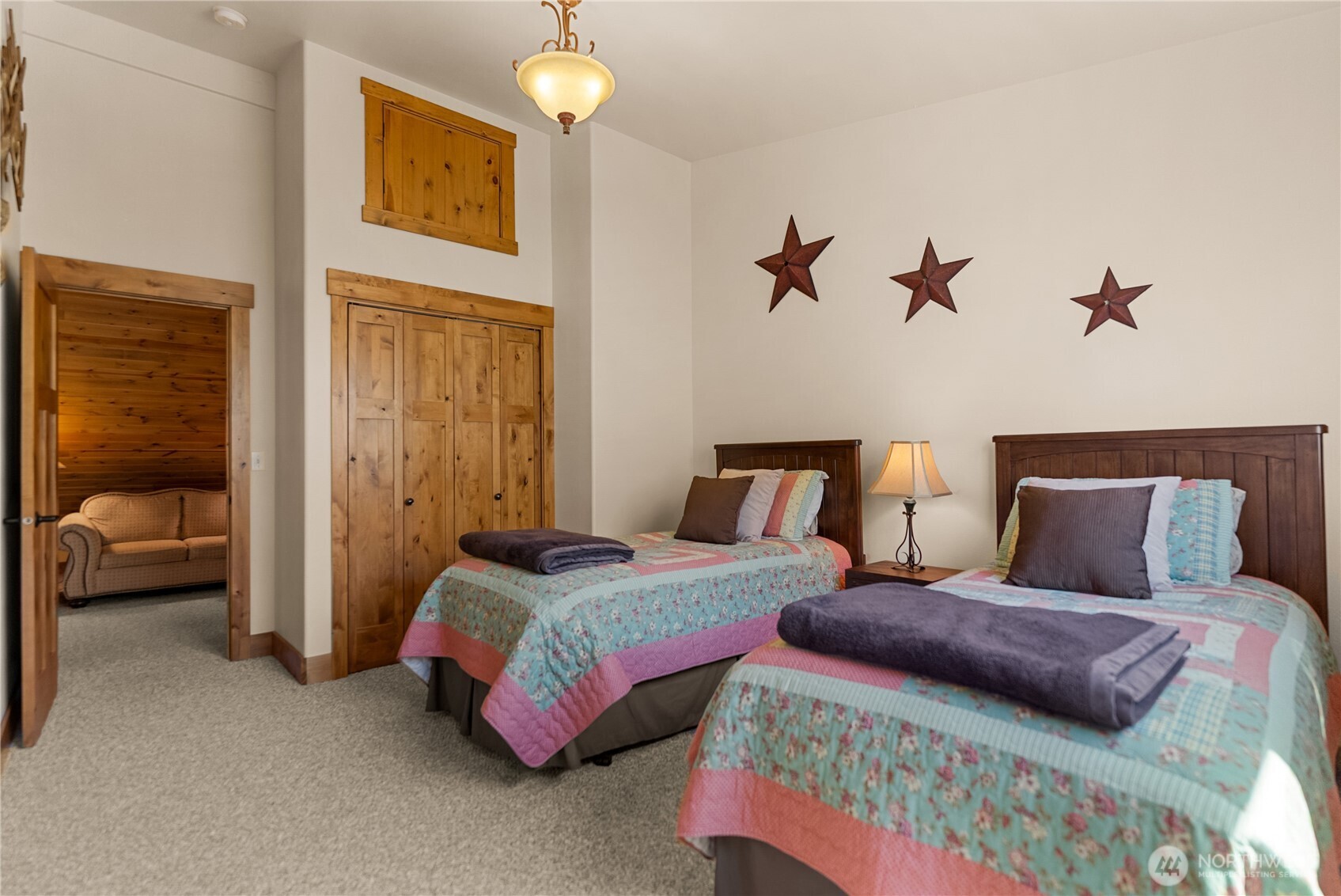 23 George Road Omak, WA 98841 - Photo 26 of 40 a bedroom with two beds and a chandelier