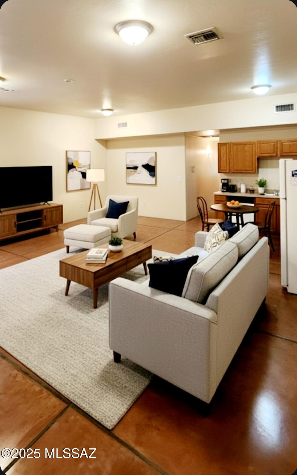533 West San Xavier Road Tucson, AZ 85713 - Photo 16 of 21 a living room with furniture and a flat screen tv