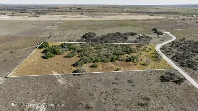 a view of a field with an ocean view