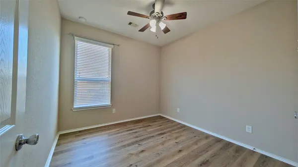 wooden floor in an empty room with a window