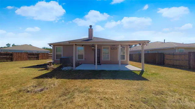 a view of a house with a swimming pool and a yard