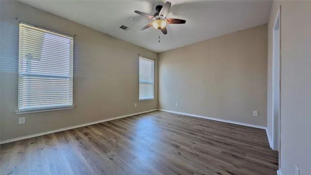 wooden floor in an empty room with a window