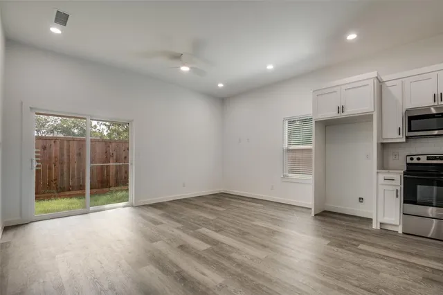 a view of kitchen with furniture and refrigerator