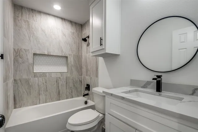 a bathroom with a sink a toilet and a mirror