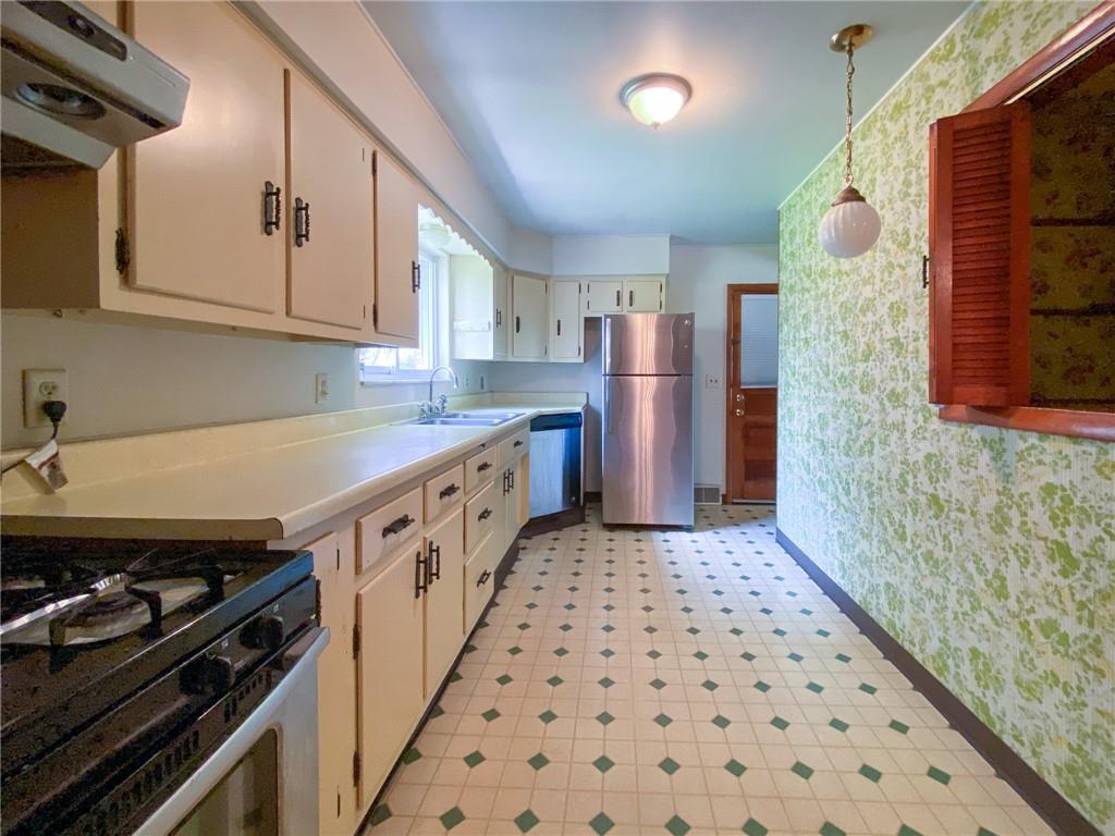 128 Clover Drive Monaca, PA 15061 - Photo 6 of 19 a kitchen with stainless steel appliances granite countertop a stove and a sink