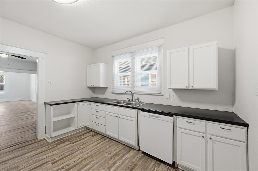 526 South Clinton Avenue Dallas, TX 75208 - Photo 13 of 25 a kitchen with granite countertop white cabinets and a sink