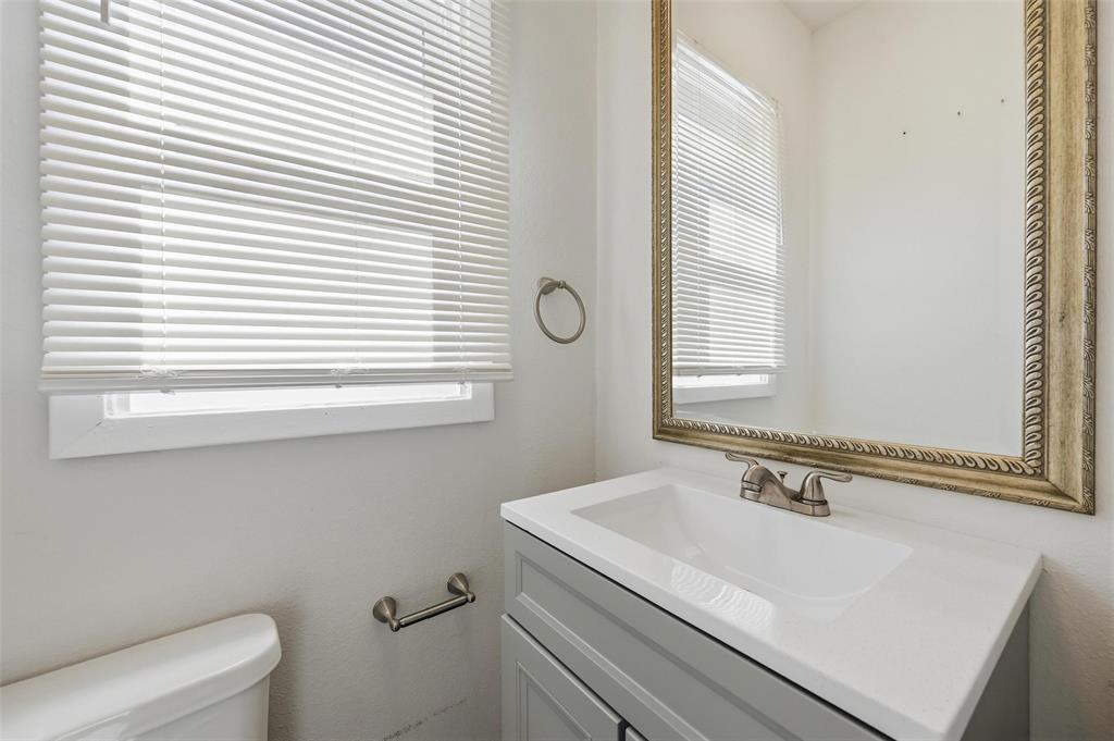 526 South Clinton Avenue Dallas, TX 75208 - Photo 20 of 25 a bathroom with a sink and a toilet