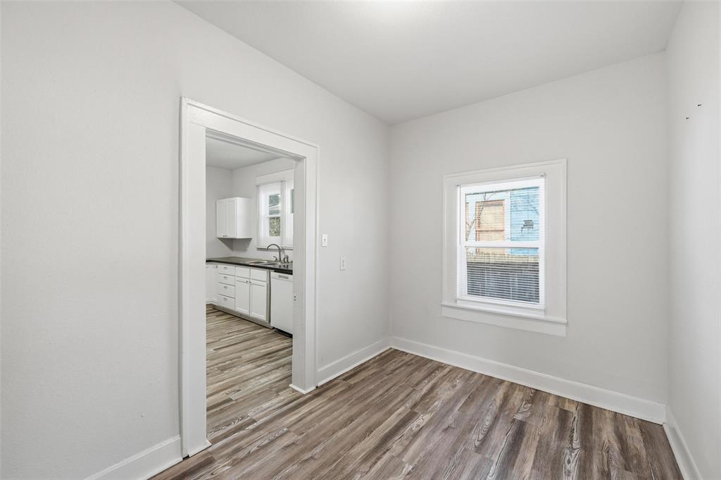 526 South Clinton Avenue Dallas, TX 75208 - Photo 9 of 25 an empty room with wooden floor and a window