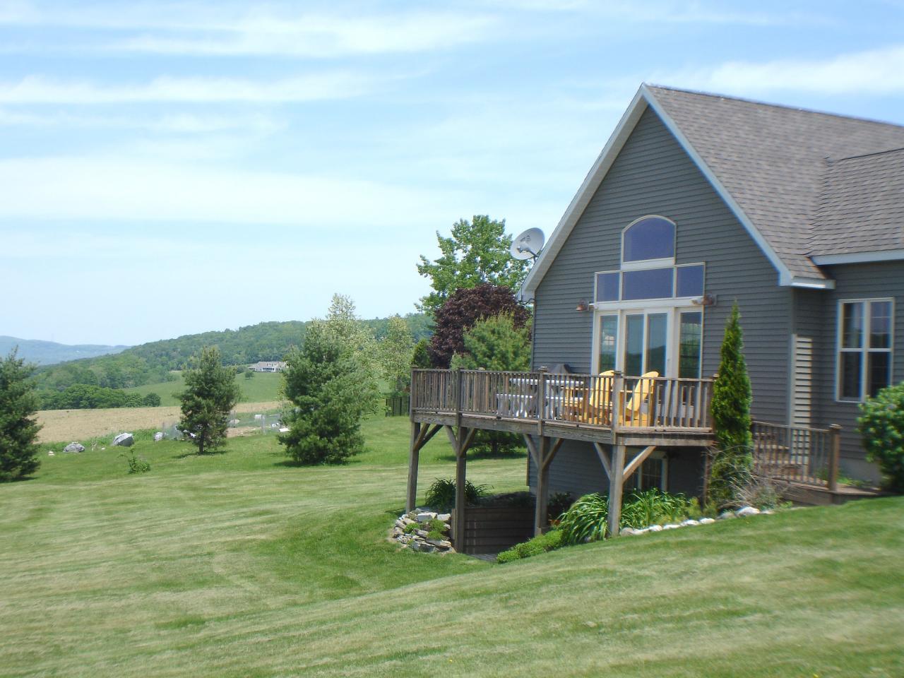 331 North Mountain Road Copake, NY 12517 - Photo 3 of 11 a front view of house with a garden and deck