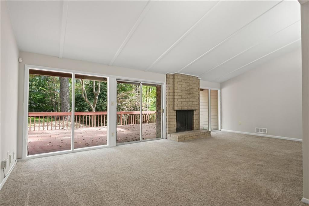 705 Edgewater Trail Sandy Springs, GA 30328 - Photo 13 of 36 a view of an empty room with a fireplace and a window
