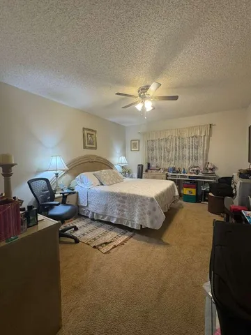 a bedroom with furniture and a chair