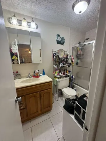 a spacious bedroom with a bed and ceiling fan