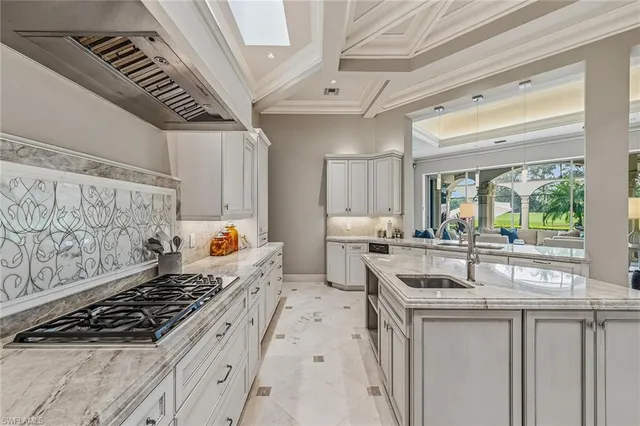 a large white kitchen with cabinets and stainless steel appliances