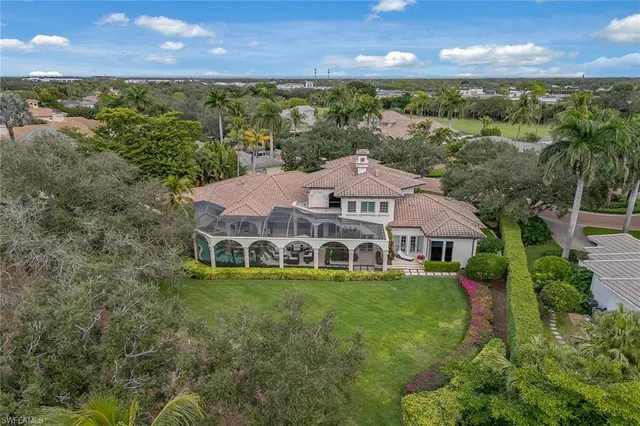 an aerial view of a house with a big yard