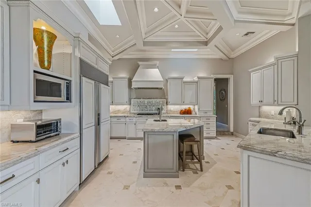 a kitchen with sink stove and cabinets