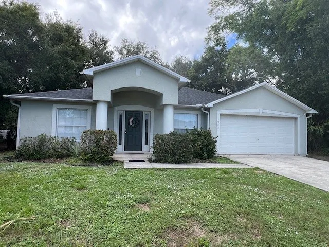 a front view of a house with yard and green space