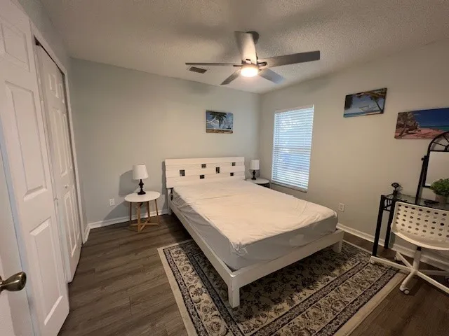 a bedroom with a bed and wooden floor