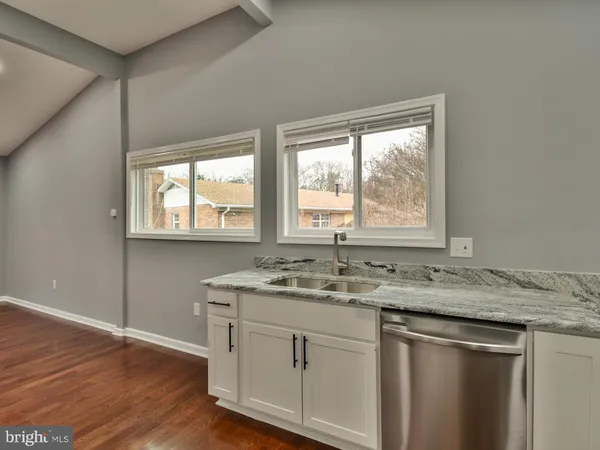 a kitchen with a granite countertop sink window and a counter space
