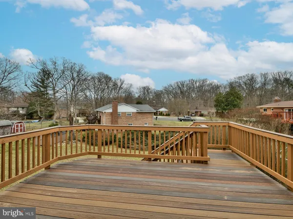 a view of a balcony with wooden floor and fence