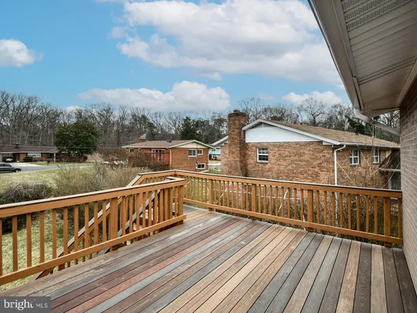 a view of balcony with wooden floor and fence