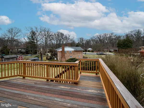 a view of balcony with wooden floor and fence