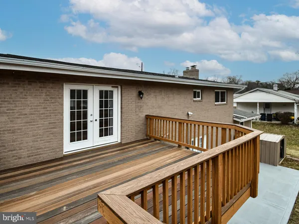 a view of a balcony with wooden floor and fence