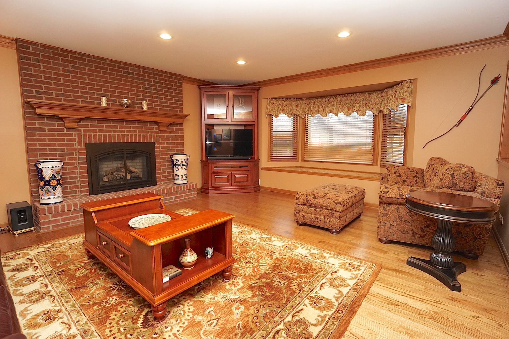 1611 Canyon Run Road Naperville, IL 60565 - Photo 13 of 23 a living room with furniture a flat screen tv and a fireplace