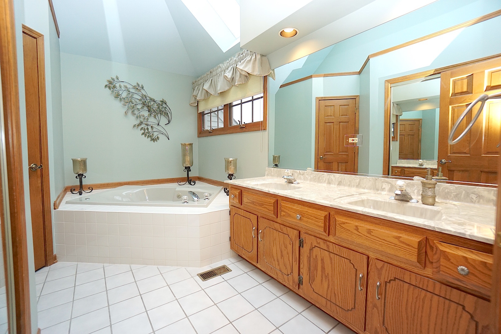 1611 Canyon Run Road Naperville, IL 60565 - Photo 15 of 23 a spacious bathroom with a tub sink and mirror