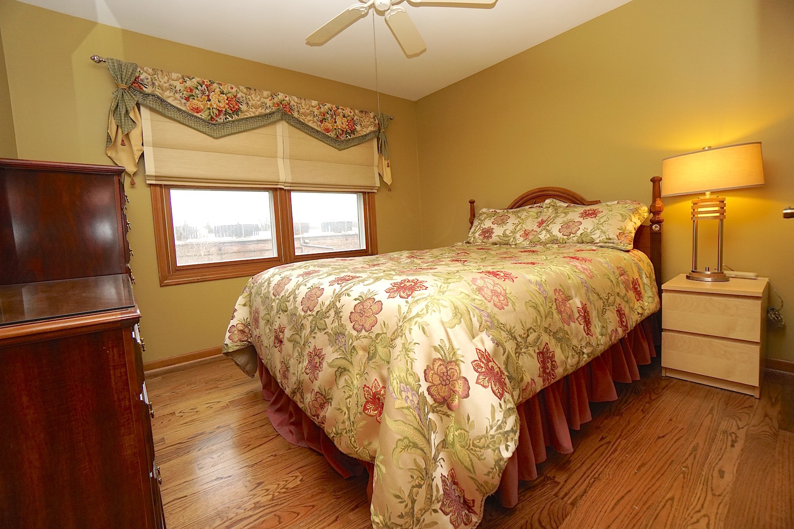 1611 Canyon Run Road Naperville, IL 60565 - Photo 18 of 23 a bedroom with a bed and a flat tv screen on dresser