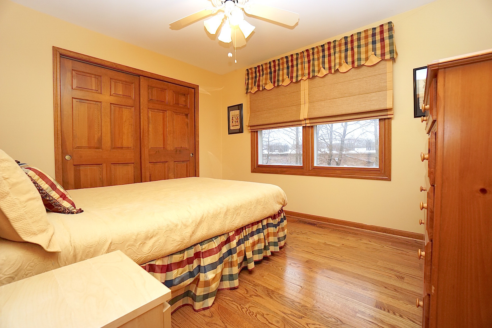 1611 Canyon Run Road Naperville, IL 60565 - Photo 19 of 23 a bedroom with a bed and wooden floor