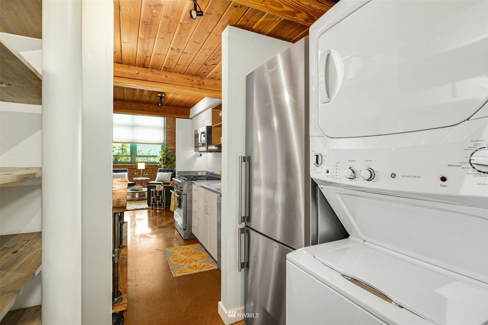 66 Bell Street, Unit 203 Seattle, WA 98121 - Photo 19 of 35 a kitchen with a refrigerator and table