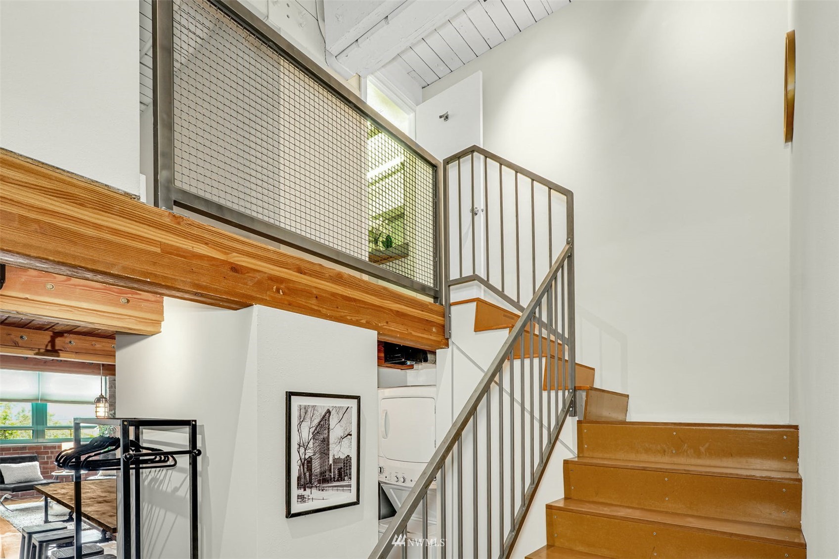 66 Bell Street, Unit 203 Seattle, WA 98121 - Photo 21 of 35 a view of staircase with lots of frames on wall and a window
