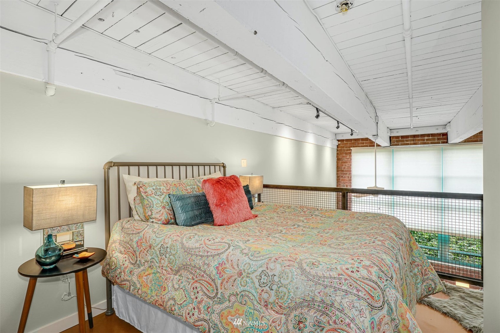 66 Bell Street, Unit 203 Seattle, WA 98121 - Photo 23 of 35 a bedroom with a bed and a window