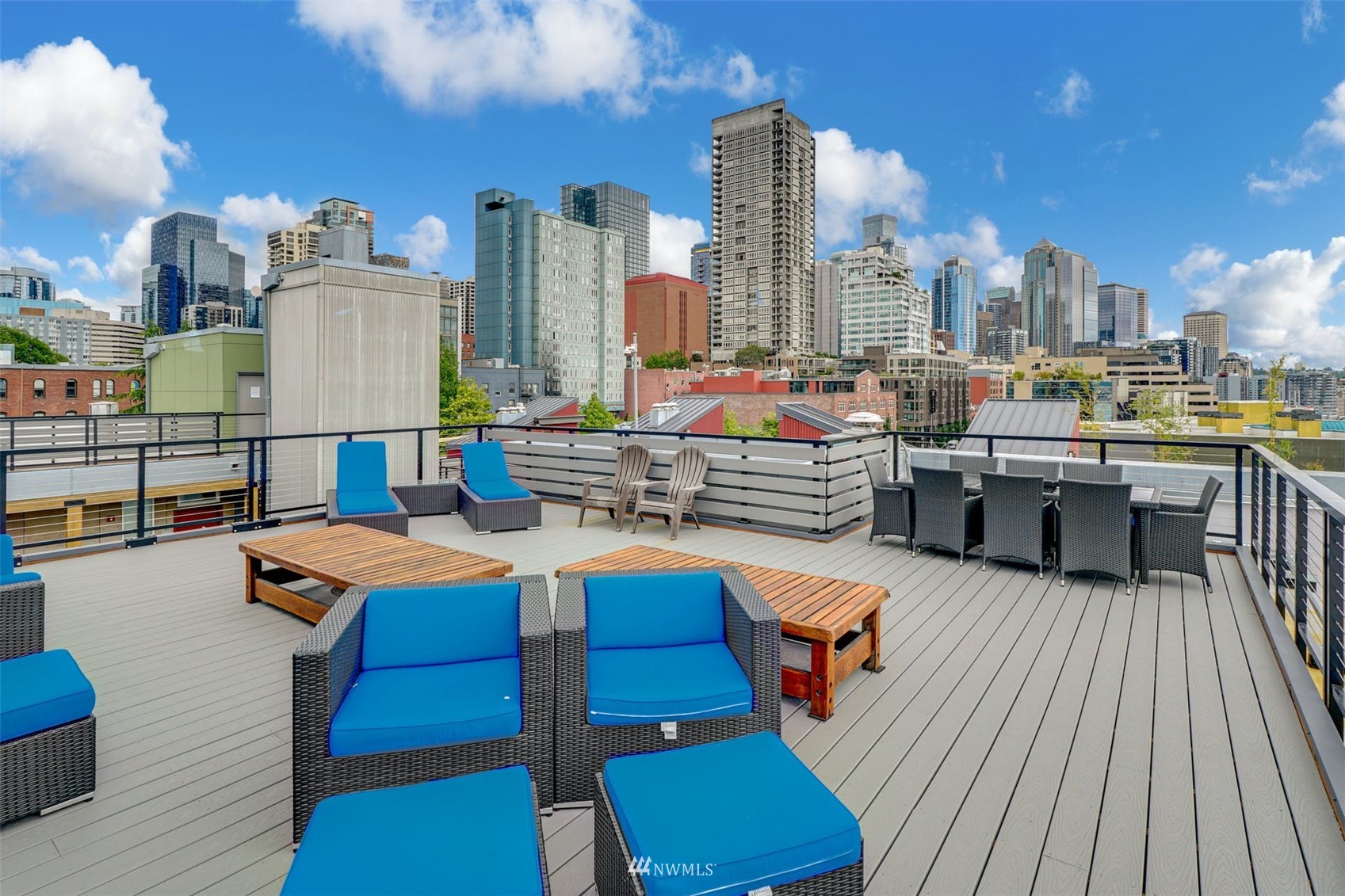 66 Bell Street, Unit 203 Seattle, WA 98121 - Photo 27 of 35 a view of a rooftop deck with chairs and wooden floor
