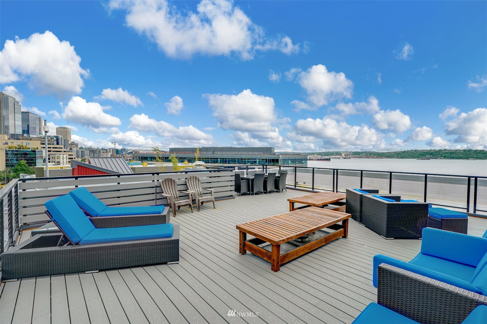 66 Bell Street, Unit 203 Seattle, WA 98121 - Photo 28 of 35 a roof deck with couches and wooden floor