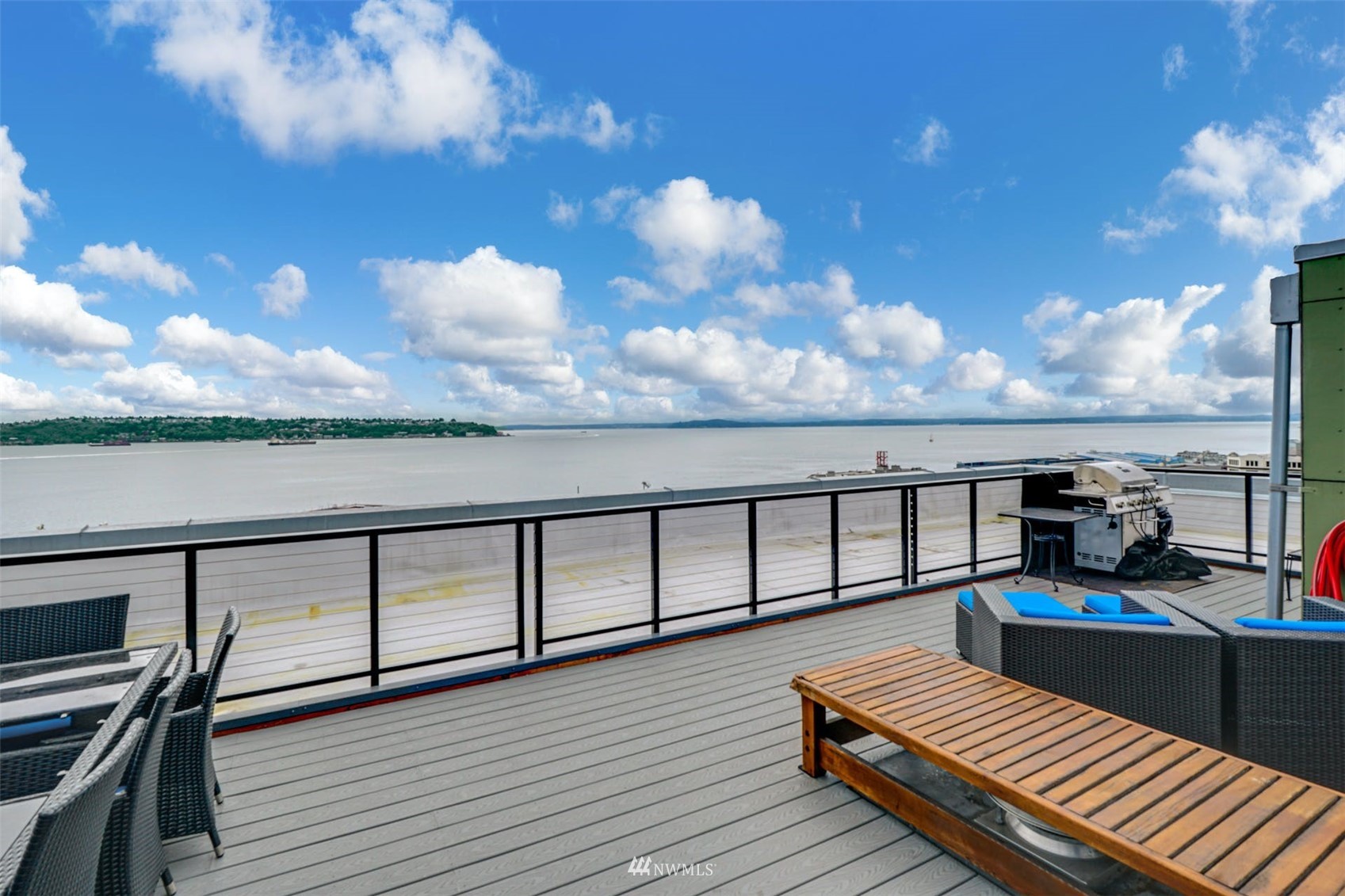 66 Bell Street, Unit 203 Seattle, WA 98121 - Photo 30 of 35 a view of a balcony with wooden floor and city view