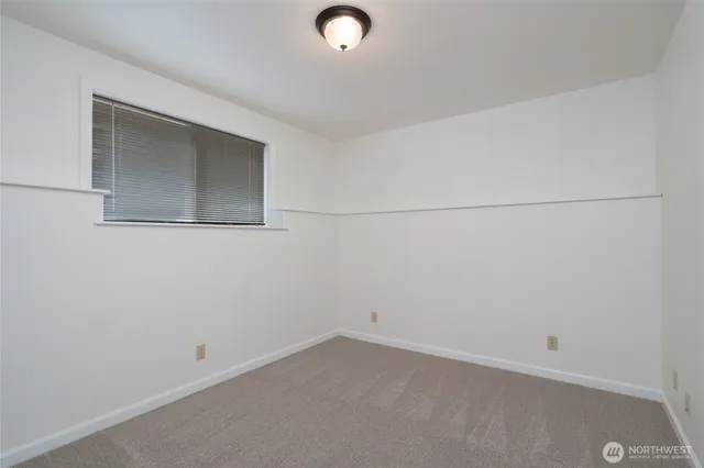 an empty room with a empty space and a window