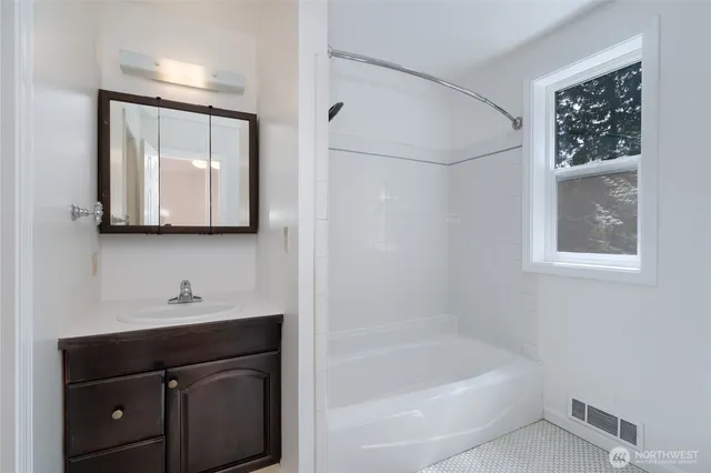 a bathroom with a bathtub and a sink