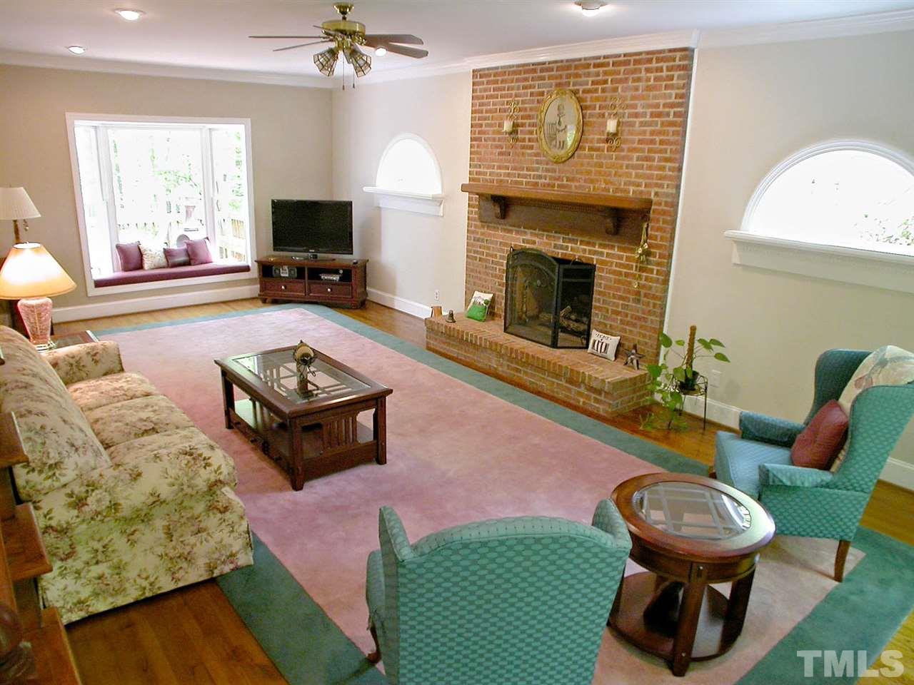 11812 Mountbatten Way Raleigh, NC 27613 - Photo 6 of 25 a living room with furniture a window and a fireplace