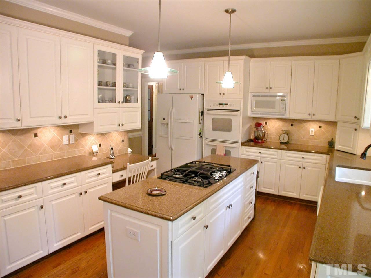 11812 Mountbatten Way Raleigh, NC 27613 - Photo 9 of 25 a kitchen with stainless steel appliances granite countertop a sink stove and refrigerator