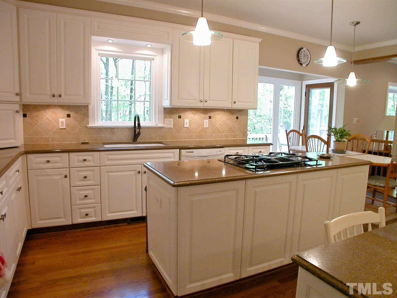 11812 Mountbatten Way Raleigh, NC 27613 - Photo 10 of 25 a kitchen with sink cabinets and window