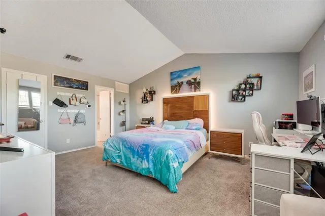 a bedroom with a bed and a desk