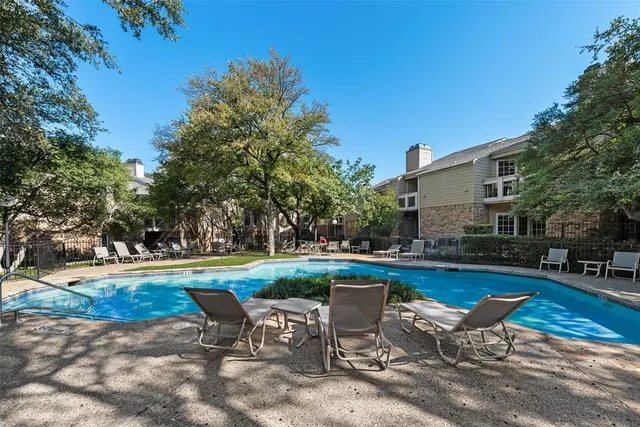a view of backyard with swimming pool and outdoor seating