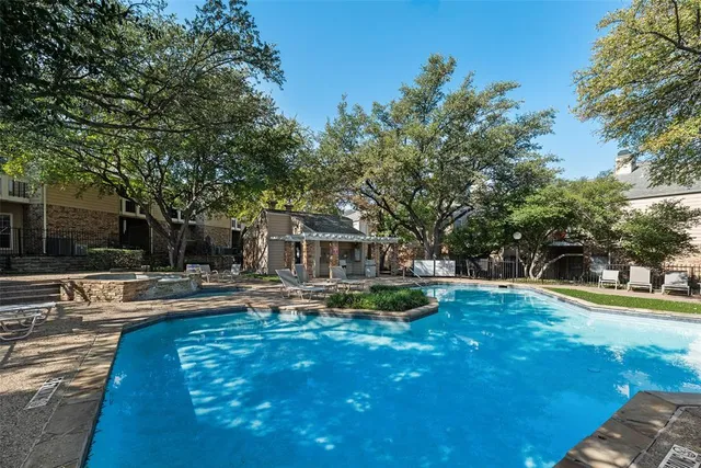 a view of a house with swimming pool and sitting area