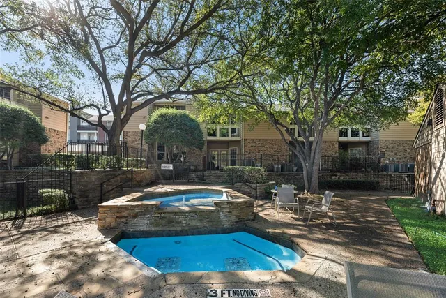 a view of a yard with plants and tree