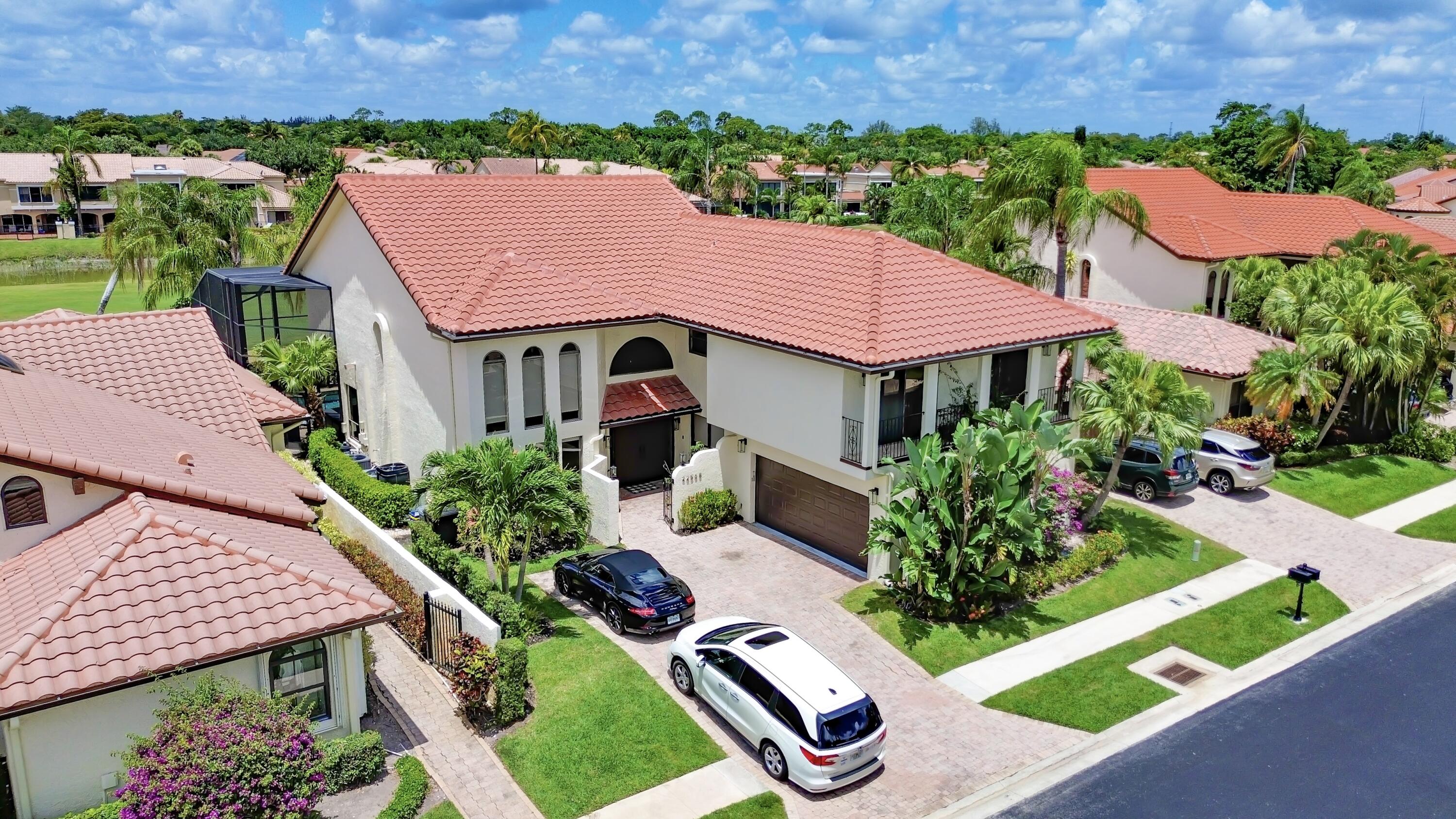 22568 Esplanada Circle Boca Raton, FL 33433 - Photo 1 of 50 an aerial view of a house with a garden and lake view