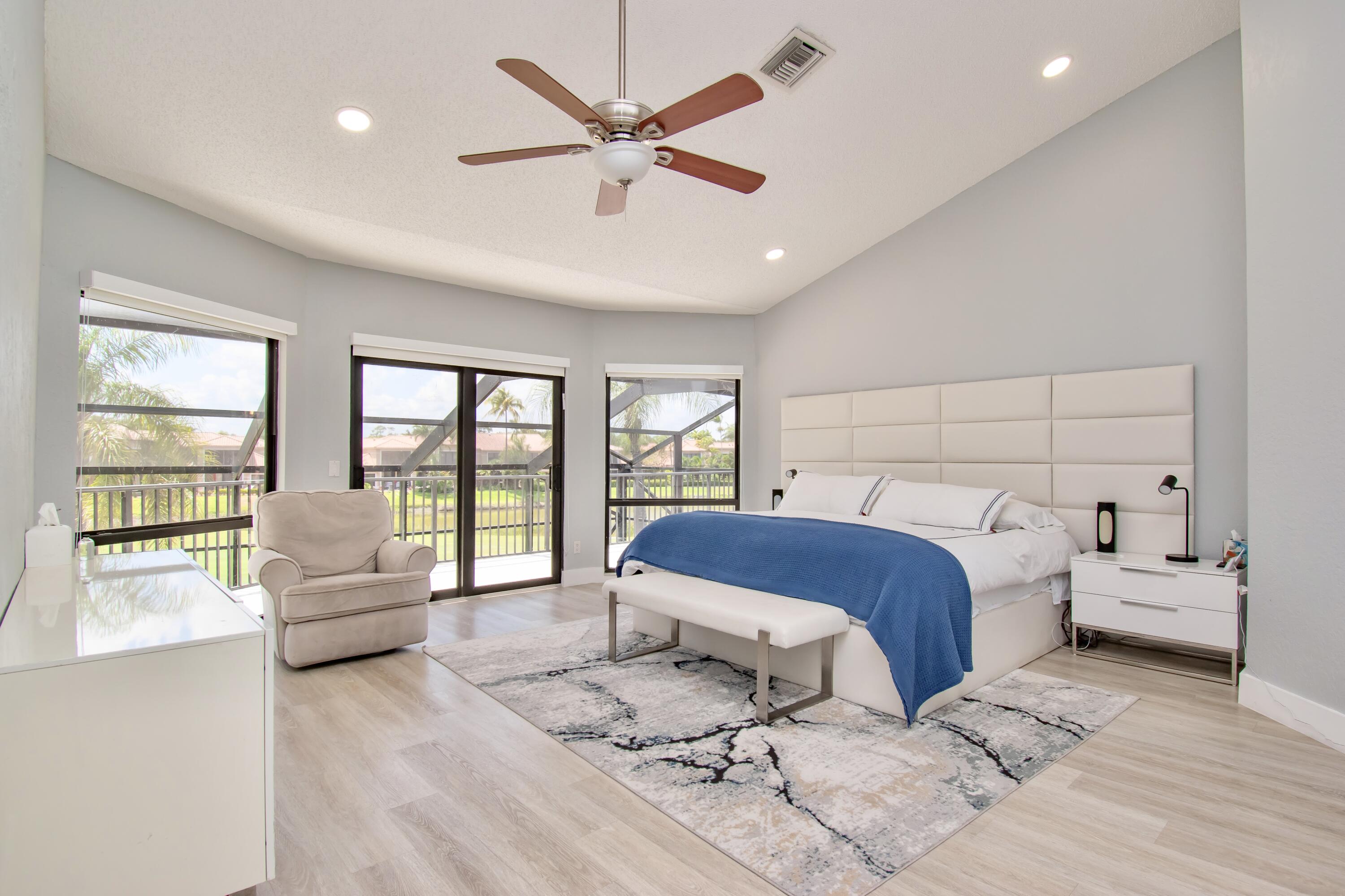 22568 Esplanada Circle Boca Raton, FL 33433 - Photo 21 of 50 a spacious bedroom with a large bed and a couch