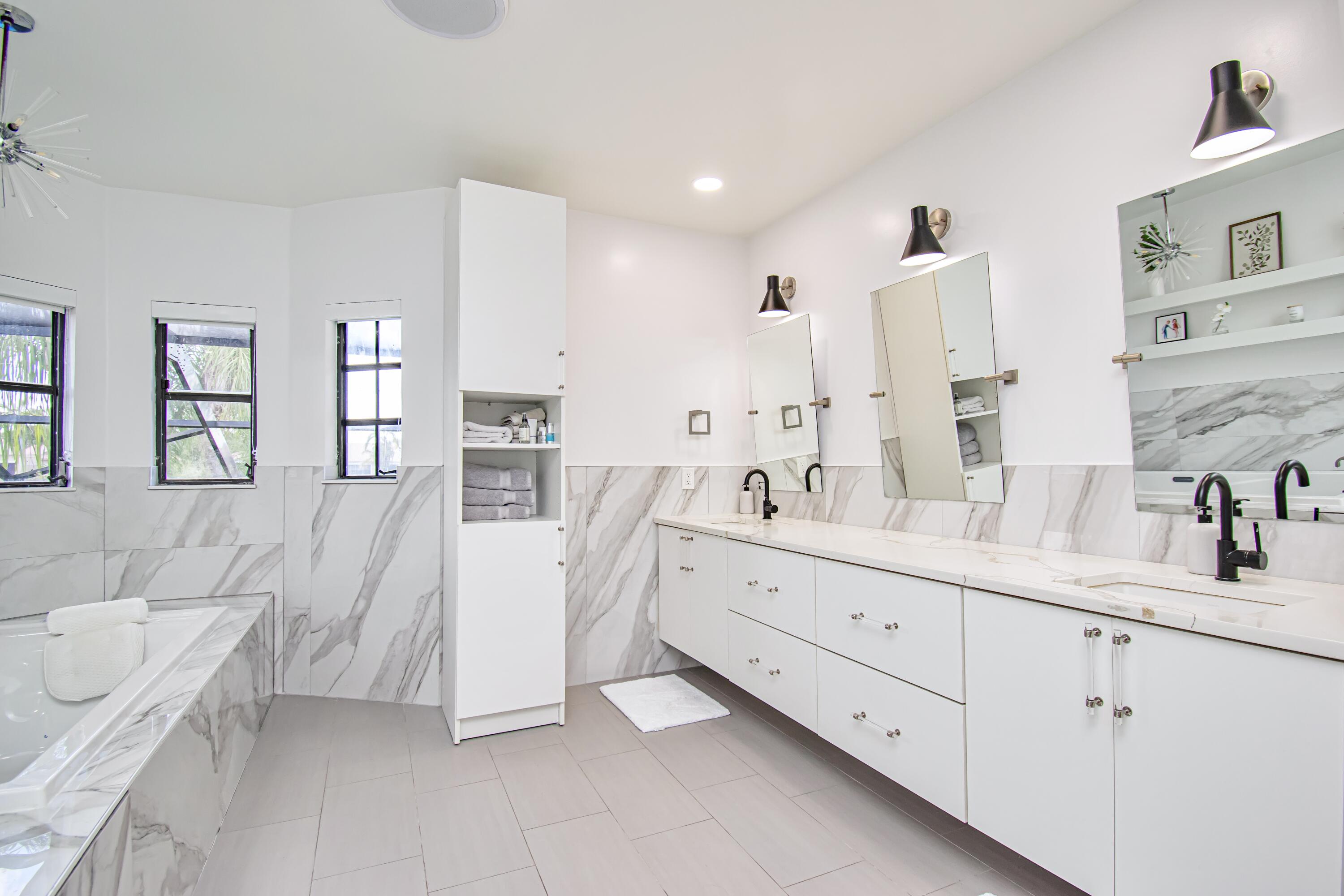 22568 Esplanada Circle Boca Raton, FL 33433 - Photo 26 of 50 a spacious en suite bathroom with a double vanity sink tub and mirror