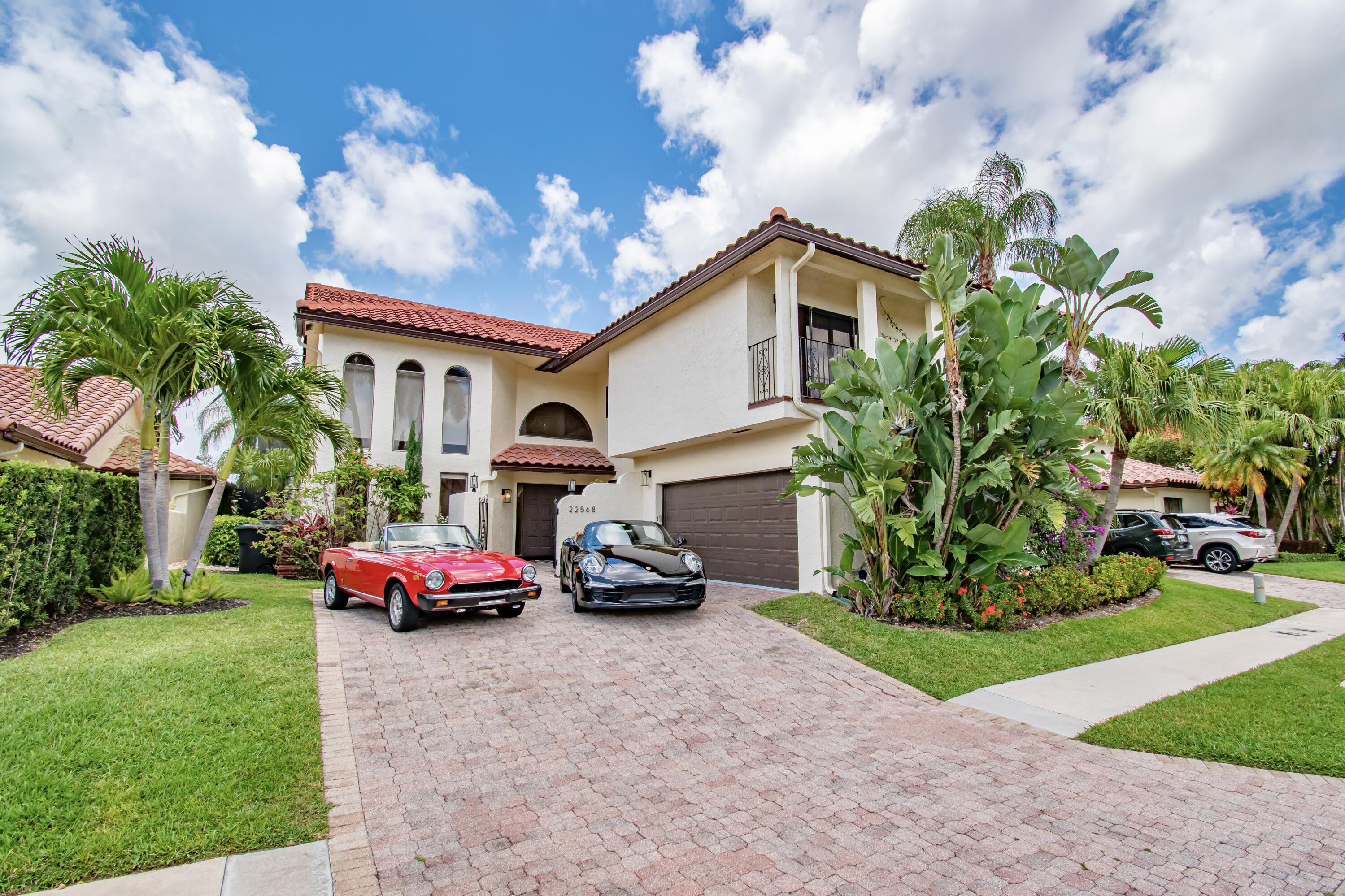 22568 Esplanada Circle Boca Raton, FL 33433 - Photo 3 of 50 a car parked in front of a house with a yard