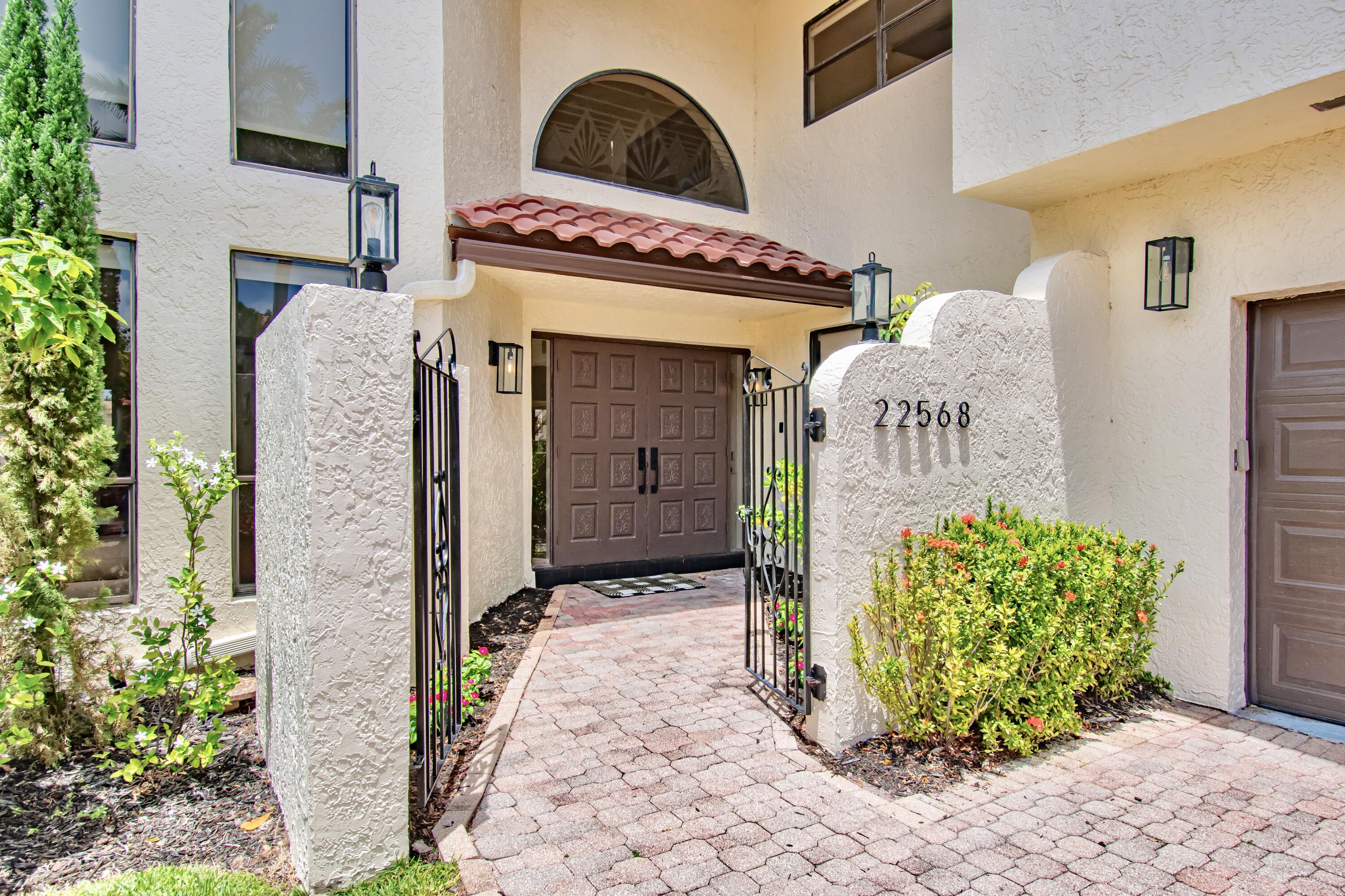 22568 Esplanada Circle Boca Raton, FL 33433 - Photo 4 of 50 a front view of a house with garden